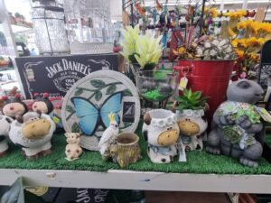Variety of ceramic and resin garden decor items and planters for sale.
