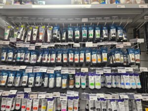 shelves stocked with various art supplies, specifically tubes of acrylic paint.